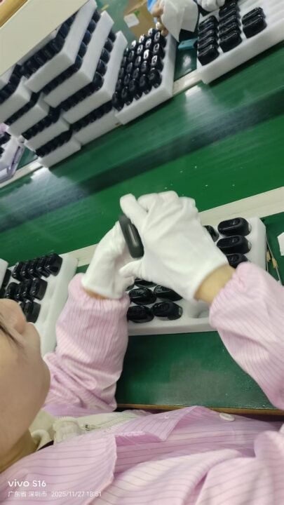 Assembly line worker inspecting empty vape hardware components in a cleanroom, Shenzhen factory